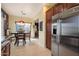 Bright dining area with wood table, pendant lighting, and stainless steel refrigerator nearby at 26408 N 53Rd Gln, Phoenix, AZ 85083