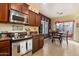 The kitchen features stainless steel appliances and dark cabinets, with a dining area nearby at 26408 N 53Rd Gln, Phoenix, AZ 85083