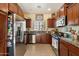 Well-equipped kitchen with stainless steel appliances, dark wood cabinets and granite countertops at 26408 N 53Rd Gln, Phoenix, AZ 85083