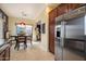 Modern kitchen featuring stainless steel refrigerator, adjacent to a dining area with a table at 26408 N 53Rd Gln, Phoenix, AZ 85083