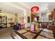 Bright eat-in kitchen boasts stainless appliances, granite counters, and wood cabinetry with a view to the living room at 26408 N 53Rd Gln, Phoenix, AZ 85083
