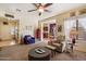 Inviting living room features neutral tones, ceiling fan, and an open floor plan to dining and kitchen at 26408 N 53Rd Gln, Phoenix, AZ 85083