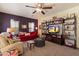 Inviting living room with ceiling fan, plush seating, and entertainment center at 26408 N 53Rd Gln, Phoenix, AZ 85083