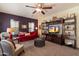 Cozy living room featuring a decorative ceiling fan, a red sofa, and stylish decor at 26408 N 53Rd Gln, Phoenix, AZ 85083