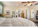 A cozy bedroom with yellow walls, ceiling fan, and neutral-toned carpet at 26408 N 53Rd Gln, Phoenix, AZ 85083