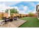 Beautiful backyard with brick patio, artificial grass, and outdoor seating areas, ideal for relaxation and entertaining at 27289 N 90Th Ave, Peoria, AZ 85383