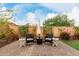 Inviting backyard with a brick patio, outdoor seating, and manicured landscaping for serene outdoor living at 27289 N 90Th Ave, Peoria, AZ 85383