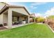 Spacious backyard featuring artificial turf, covered patio, and comfortable seating areas for outdoor living at 27289 N 90Th Ave, Peoria, AZ 85383
