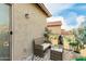Cozy balcony area with comfortable seating and views of lush greenery, a perfect outdoor retreat at 27289 N 90Th Ave, Peoria, AZ 85383