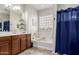 Bright bathroom featuring a soaking tub, glass block window, double sink vanity and tiled floor at 27289 N 90Th Ave, Peoria, AZ 85383