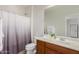 Bathroom featuring a single sink vanity, shower curtain, and neutral decor at 27289 N 90Th Ave, Peoria, AZ 85383
