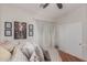Bedroom with neutral walls, ceiling fan, curtains, and stylish decorative artwork above bed at 27289 N 90Th Ave, Peoria, AZ 85383