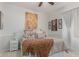 Cozy bedroom featuring a ceiling fan, neutral walls, white wainscoting, and stylish decorative artwork at 27289 N 90Th Ave, Peoria, AZ 85383
