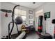Exercise room featuring rubber floors, boxing equipment, wall art, and natural light at 27289 N 90Th Ave, Peoria, AZ 85383
