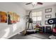 Exercise room featuring rubber floors, workout equipment, wall art, and natural light at 27289 N 90Th Ave, Peoria, AZ 85383