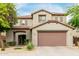 Charming two-story home featuring a neutral palette, two-car garage, and welcoming landscaping at 27289 N 90Th Ave, Peoria, AZ 85383