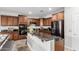 Kitchen features granite counters, dark wood cabinets, and stainless steel appliances at 27289 N 90Th Ave, Peoria, AZ 85383