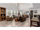 Open concept living area featuring high ceilings, large windows, and modern tile flooring at 27289 N 90Th Ave, Peoria, AZ 85383