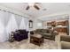 Bright and airy living room featuring tile floors, neutral furniture, and views into the kitchen at 27289 N 90Th Ave, Peoria, AZ 85383