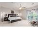 Main bedroom with ceiling fan and sliding door to a private balcony at 27289 N 90Th Ave, Peoria, AZ 85383
