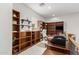 Home office with built-in bookshelves and natural lighting at 27289 N 90Th Ave, Peoria, AZ 85383