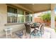 Charming covered patio area with a dining table and comfortable seating, ideal for outdoor meals at 27289 N 90Th Ave, Peoria, AZ 85383