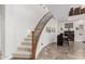Elegant staircase features a wood banister and wrought iron detailing at 27289 N 90Th Ave, Peoria, AZ 85383