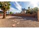 Expansive backyard featuring desert landscaping, a tall privacy wall, patio and a shaded pergola area at 3106 S Extension Rd, Mesa, AZ 85210
