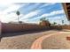 The backyard features desert landscaping and a low brick wall surrounding the property at 3106 S Extension Rd, Mesa, AZ 85210