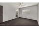 Bright bedroom with ceiling fan, adjacent bathroom, and natural light from window at 3106 S Extension Rd, Mesa, AZ 85210