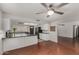 Kitchen features hardwood floors, white cabinets, black countertops, stainless steel appliances, and an open layout at 3106 S Extension Rd, Mesa, AZ 85210