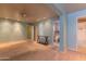 Spacious basement featuring blue walls, carpet, and an ensuite bathroom and storage closet at 323 E Griswold Rd, Phoenix, AZ 85020