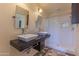 Bathroom with double sinks, decorative walls, and separate toilet and shower at 323 E Griswold Rd, Phoenix, AZ 85020