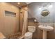 Shower featuring pebble flooring, tile walls, and an open concept with a pedestal sink at 323 E Griswold Rd, Phoenix, AZ 85020