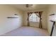 Primary bedroom featuring new carpet, a window, and built in shelving at 323 E Griswold Rd, Phoenix, AZ 85020