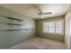 Relaxing bedroom featuring a ceiling fan, shelving, and a bright window at 323 E Griswold Rd, Phoenix, AZ 85020