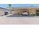 Spacious carport featuring brick walls and a paved driveway, offering covered parking and convenience at 323 E Griswold Rd, Phoenix, AZ 85020