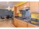 Updated kitchen boasting stainless steel appliances and granite countertops, perfect for cooking and entertaining at 323 E Griswold Rd, Phoenix, AZ 85020
