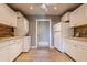 Well-lit laundry room with white cabinets and ample storage space at 323 E Griswold Rd, Phoenix, AZ 85020