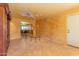 Cozy living room with tile floors, featuring a pass-through to the dining area for seamless entertaining at 323 E Griswold Rd, Phoenix, AZ 85020
