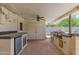 Outdoor kitchen features stainless steel grill, beverage cooler, ample counter space and ceiling fan at 323 E Griswold Rd, Phoenix, AZ 85020