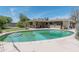 Backyard with large in-ground pool, patio, outdoor kitchen, and mature landscaping at 323 E Griswold Rd, Phoenix, AZ 85020