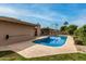 Beautiful backyard featuring a sparkling blue pool, well-maintained lawn, and ample space for leisure and recreation at 3255 E Malapai Dr, Phoenix, AZ 85028