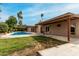 Inviting backyard with a refreshing pool, lush lawn, and a covered patio, perfect for outdoor relaxation and entertaining at 3255 E Malapai Dr, Phoenix, AZ 85028