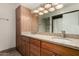 A bathroom featuring double sinks, granite countertops, and modern lighting at 3255 E Malapai Dr, Phoenix, AZ 85028