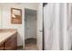 A view of a modern bathroom with a wood-framed mirror and tiled floors at 3255 E Malapai Dr, Phoenix, AZ 85028
