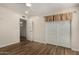 A bedroom with a closet with sliding doors and hardwood floors at 3255 E Malapai Dr, Phoenix, AZ 85028