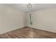 Cozy bedroom featuring a window and plank flooring at 3255 E Malapai Dr, Phoenix, AZ 85028