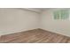 Bedroom with a window for natural light and plank flooring at 3255 E Malapai Dr, Phoenix, AZ 85028