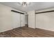 Neutral bedroom with modern light fixture and plank flooring at 3255 E Malapai Dr, Phoenix, AZ 85028